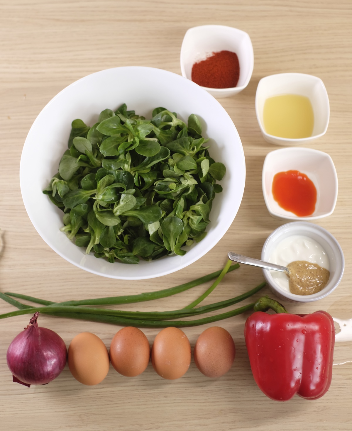 Spicy egg salad ingredients with lamb's lettuce, eggs, red pepper, red onion, Greek yogurt, mustard and spices