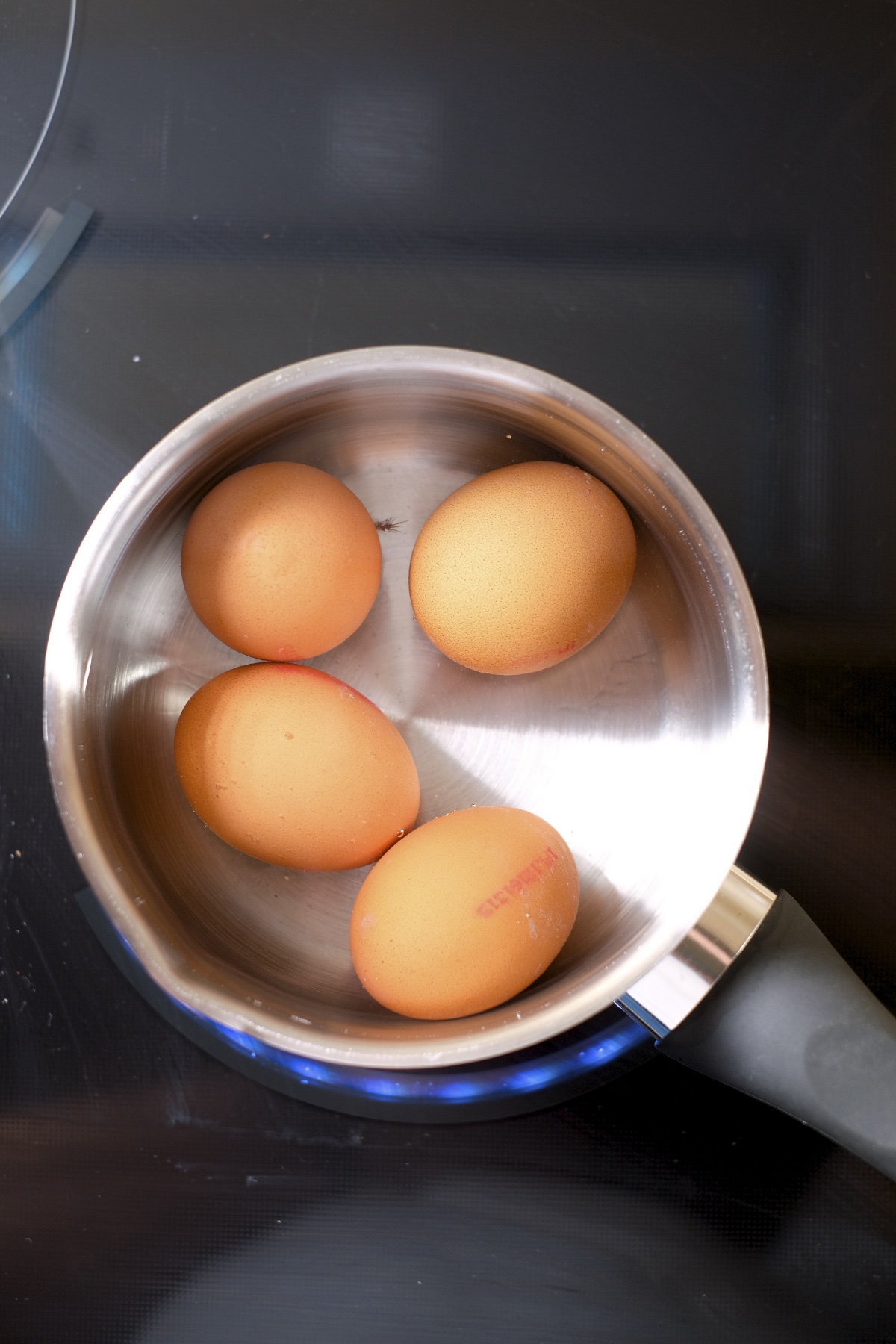 Boiling eggs in a pot on the stove for avocado egg salad recipe