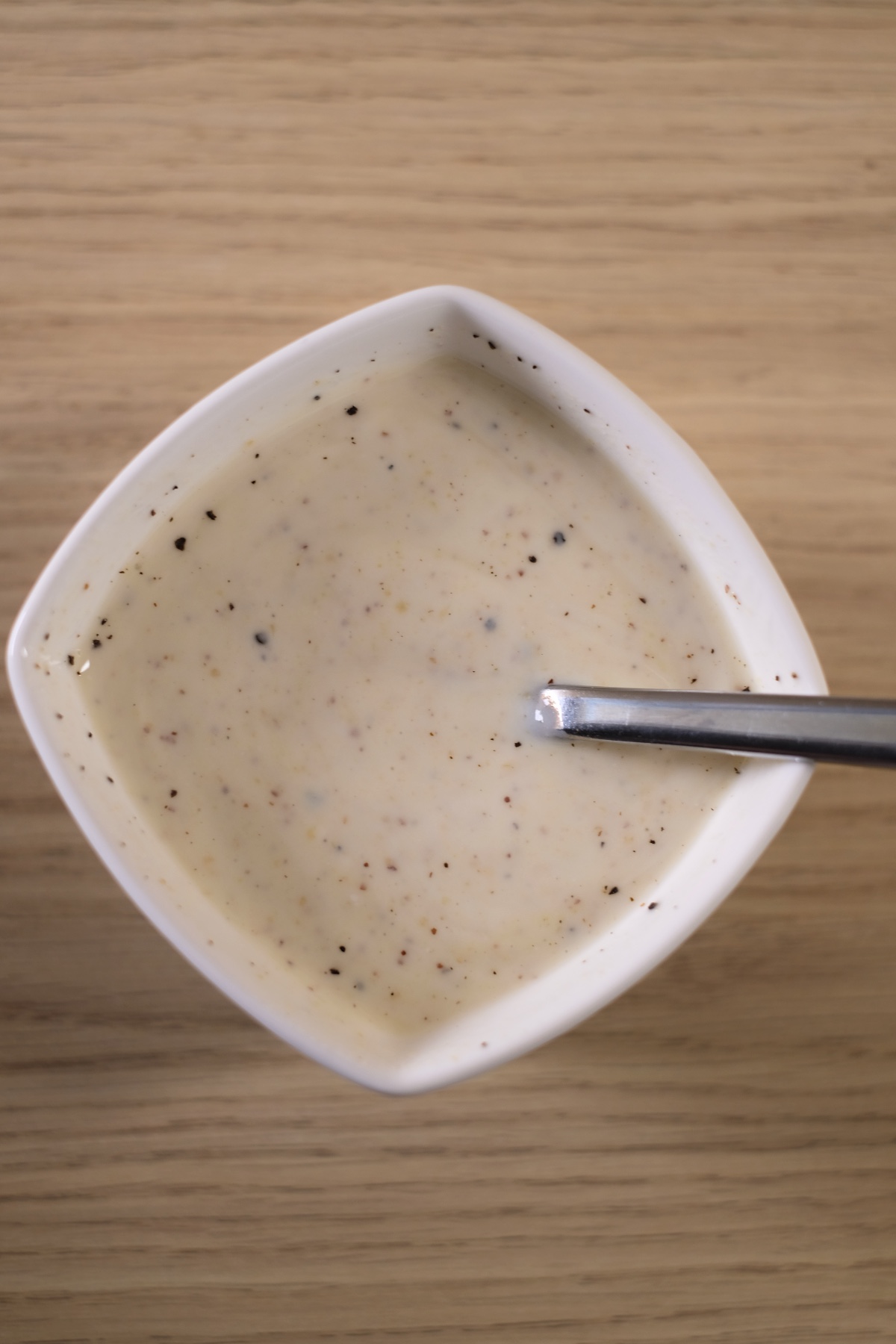 Creamy yogurt mustard dressing mixed for avocado egg salad