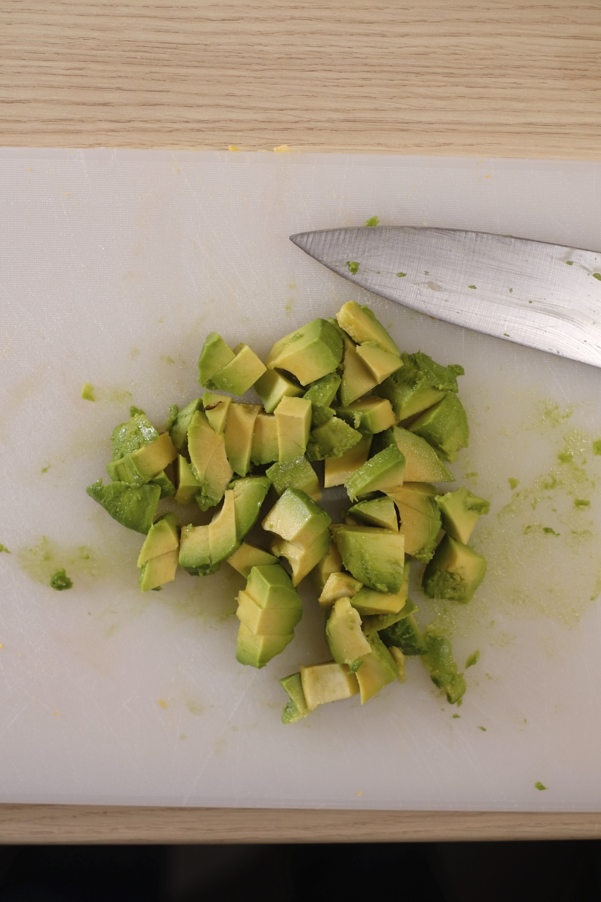Chopped avocado pieces on a cutting board for avocado egg salad
