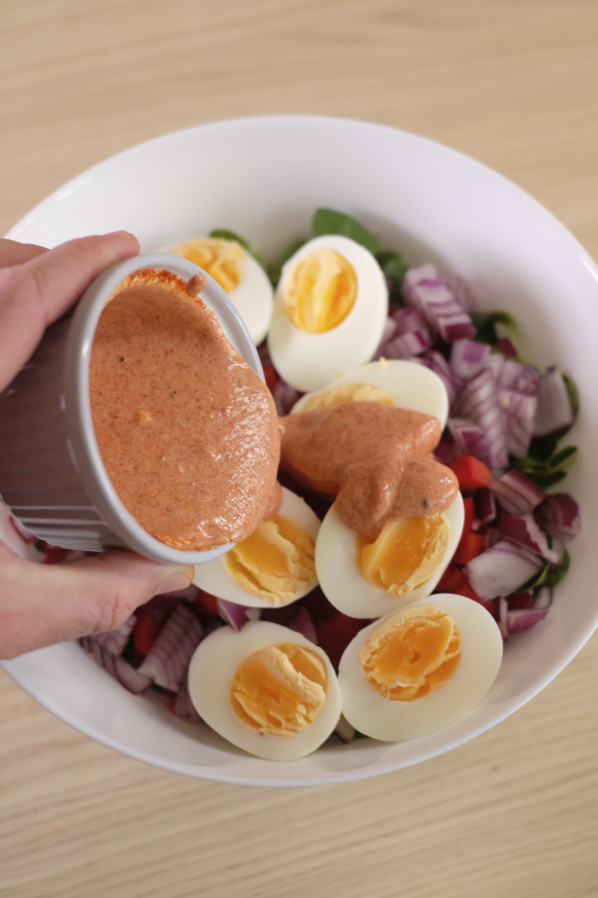 I poured a spicy yogurt dressing with sriracha over eggs and vegetables to make spicy egg salad