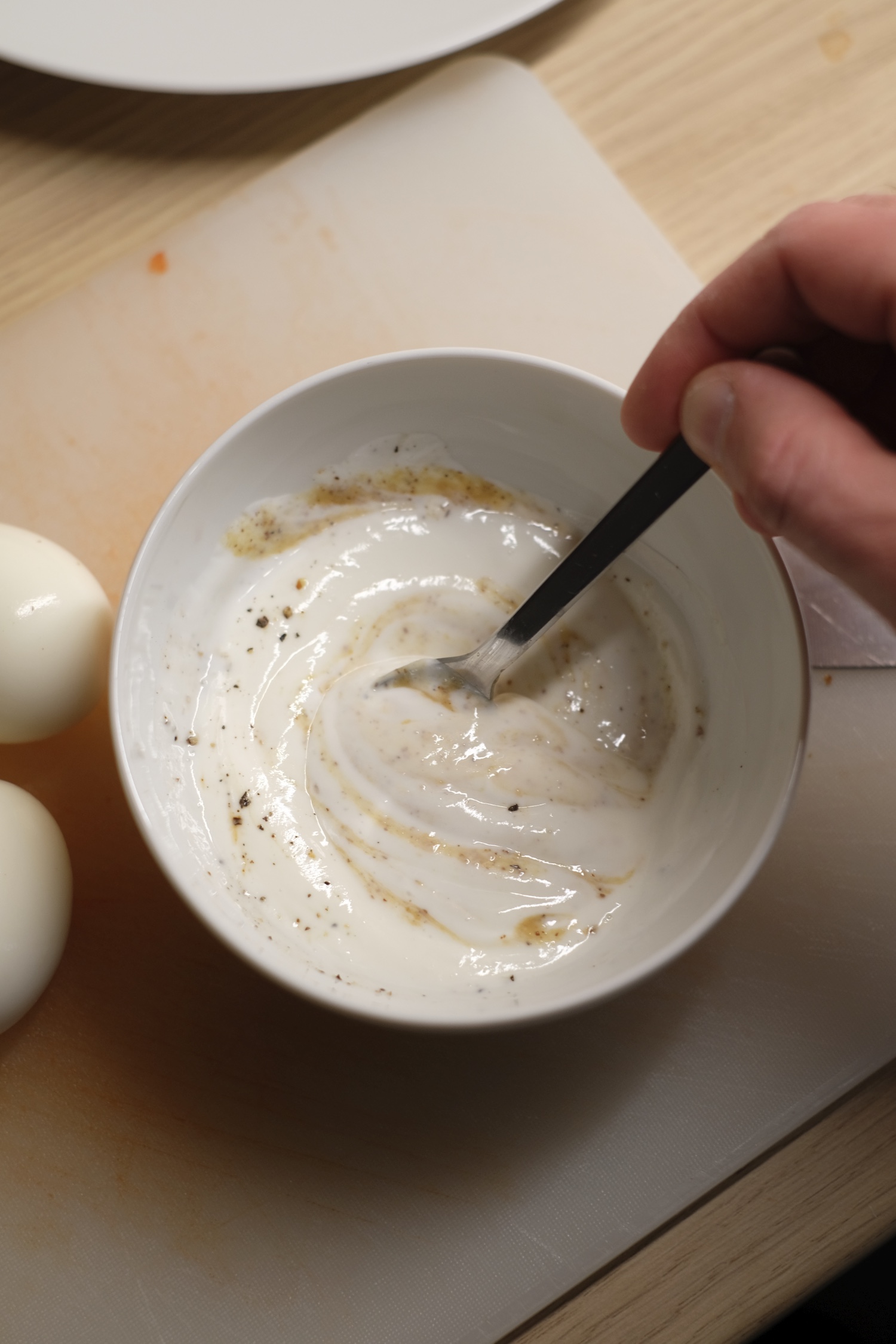 mixing yogurt mustard dressing in a small bowl