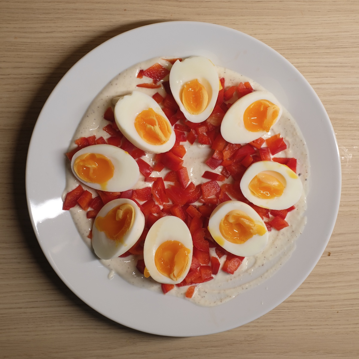egg salad ingredients arranged on a plate before mixing